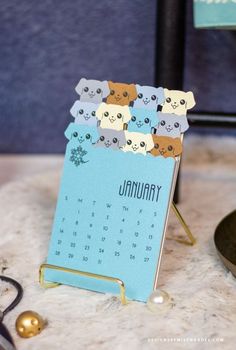 a calendar with cats on it sitting on a table