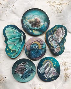 four ceramic plates with different designs on them