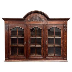 an old wooden bookcase with glass doors and carvings on the front, isolated against a white background