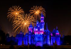 fireworks in the sky above a castle with turrets