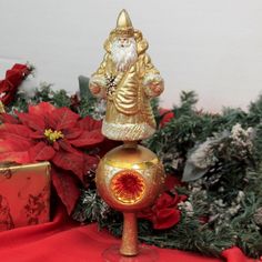 a glass figurine sitting on top of a table next to some christmas decorations