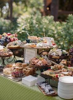 a table full of food and desserts on it's sides in the park