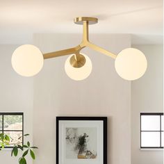 a living room with white couches and two round lights on the ceiling above them