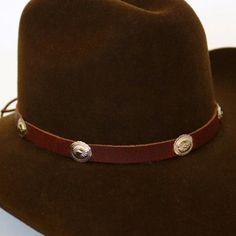 This 1/2 inch thick leather hatband is decorated with oval metal conchos. It is adjustable with a leather string tie.Made in the USASoft Genuine Leather*This product is for 1 single hat band. Hat not included. 100% Leather Austin Accent Hat Band Black Leather Silver Conchos Adjustable Adjustable Short Brim Hat Bands For Ranch, Adjustable Short Brim Top Hat For Rodeo, Adjustable Brown Top Hat For Ranch, Adjustable Vintage Leather Hat, Custom Adjustable Brown Hat Bands, Western Style Top Hat With Adjustable Short Brim, Adjustable Leather Hat With Flat Crown, Adjustable Wide Brim Top Hat For Ranch, Adjustable Custom Top Hat For Country Events