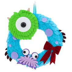 a blue and green wreath decorated with googly eyes