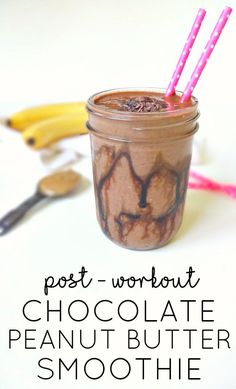 chocolate peanut butter smoothie in a mason jar with two pink straws on top