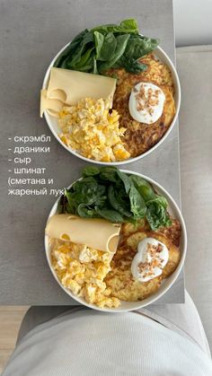 two white bowls filled with food on top of a table