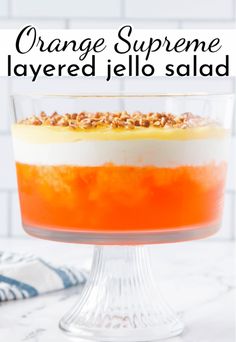 orange supreme layered jello salad in a glass dish on a marble countertop with text overlay