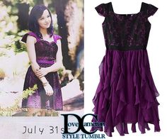 a purple dress with black lace on it and an image of a woman in the background