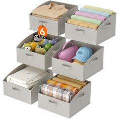 four bins with towels, blankets and other items in them on a white background