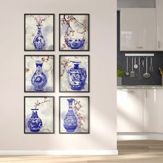 four blue and white vases are hanging on the wall in a kitchen with wood flooring