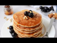 a stack of pancakes with blueberries and walnuts on top