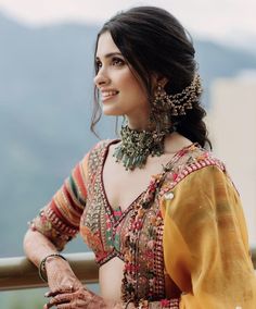 a woman in a yellow sari and matching jewelry