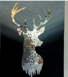 a stained glass deer head with large, shiny antlers on it's face