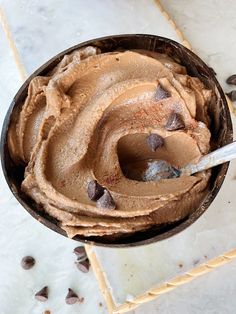 a bowl filled with chocolate ice cream on top of a counter