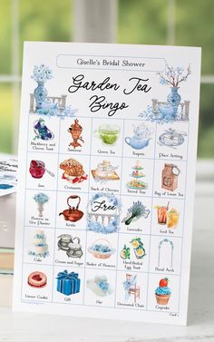 the garden tea song book is sitting on a table next to some books and vases