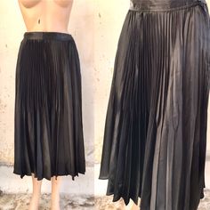 Multi pleated long black skirt, made out of satiny polyester, 90s or 80s vintage Nice glossy inky black fabric with two levels of pleats  In the upper part they are narrower and in the lower part wider. Closes with a side zipper and a button A classic and classy piece, that never goes out of the fashion, necessary for any female wardrobe   ‼️Be aware! Only one item is available! 🌀MEASUREMENTS: (Garment is Lying flat) *WAIST : 13.5" / 34.5 cm *HIPS : free  *LENGTH - Measured from waist to last h Retro Black Pleated Skirt, Luxury Black Box Pleat Pleated Skirt, Black Pleated Full-length Skirt, Black Pleated A-line Maxi Skirt, Black Non-stretch Long Pleated Skirt, Long Black, Black Skirt, Vintage Store, Black Fabric