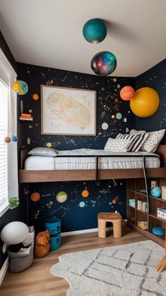 a child's bedroom with planets painted on the wall and a bunk bed in the corner