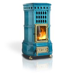 a blue stove that is sitting in the middle of a white floor with flames coming out of it