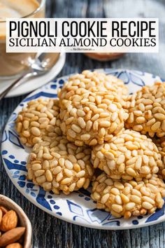 some cookies are on a blue and white plate with almonds next to it, along with a cup of coffee