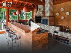 a kitchen with an oven, counter top and bar stools next to the window