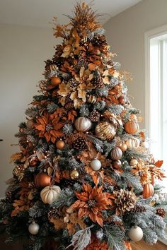 a decorated christmas tree with gold and silver ornaments