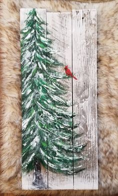 a painting of a red bird sitting on top of a pine tree in the snow