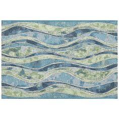 a blue and green rug with wavy lines