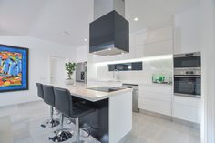 a kitchen with an island and bar stools