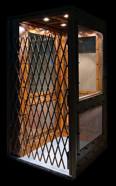 the inside of a wooden box with lattice design on it's sides and doors