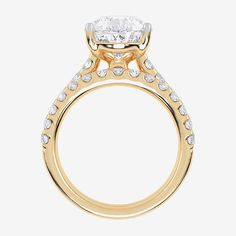 a yellow gold engagement ring with an oval cut diamond in the center and side stones