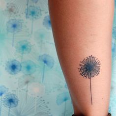 a small dandelion tattoo on the leg