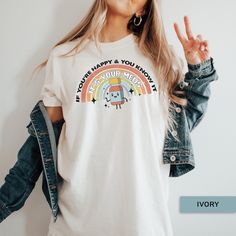 a woman wearing a t - shirt that says happy and you know it