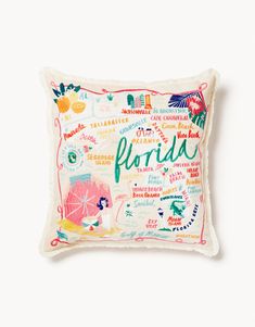 a pillow with the word florida written in different languages on it, and an image of a