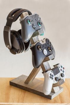 two video game controllers are stacked on top of each other with headsets attached to them