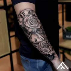 a man with a clock and roses tattoo on his arm