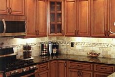 a kitchen with wooden cabinets and granite counter tops is pictured in this image from the front view