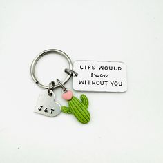 a keychain with two hearts and a cactus on it