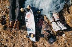 two skateboarders sitting on the ground with their feet propped up against each other