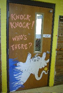 a door with writing on it that says knock knock who's there? and an image of a ghost