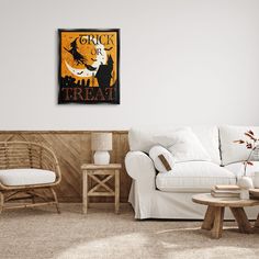 a living room filled with furniture and a poster on the wall above it that says trick or treat