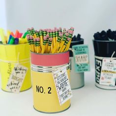 there are many different colored pencils in the jar on the table next to each other