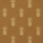 a brown background with white pineapples on it