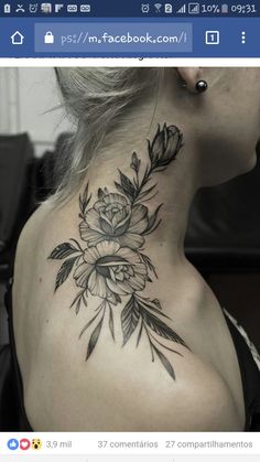 the back of a woman's neck with flowers and leaves on her left side