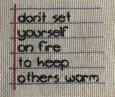 a piece of fabric with the words don't set yourself on fire to keep others warm