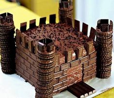 a cake made to look like a castle with towers and gates on it's sides