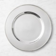 an empty silver plate on a marble surface