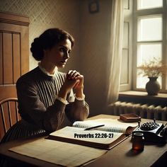 a woman sitting at a table in front of a book and calculator with her hands clasped