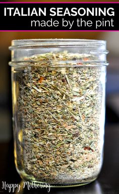 a jar filled with different types of herbs on top of a wooden table next to text that reads italian seasoning made by the pint