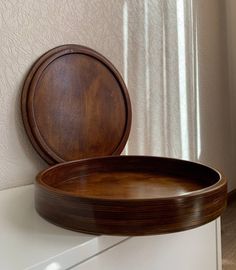 a wooden tray sitting on top of a white dresser